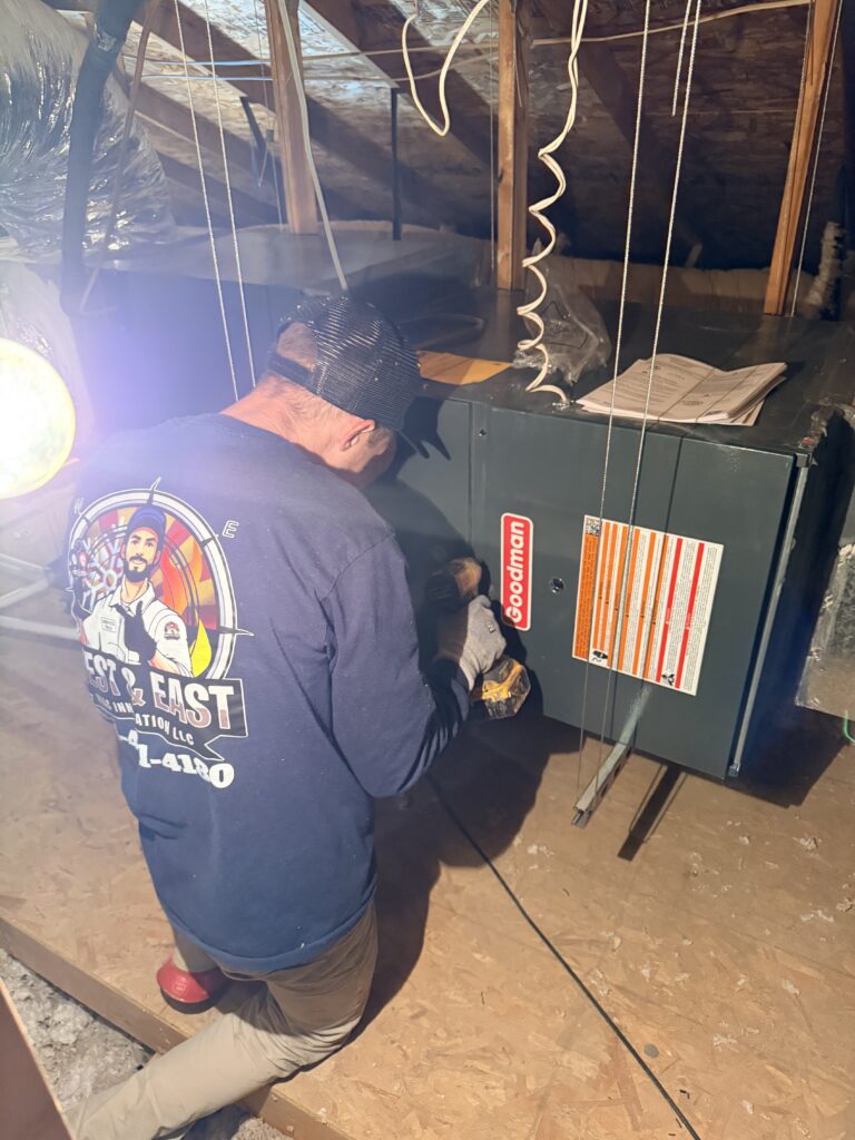 EMEPLOYE WORKING ON A AC UNIT